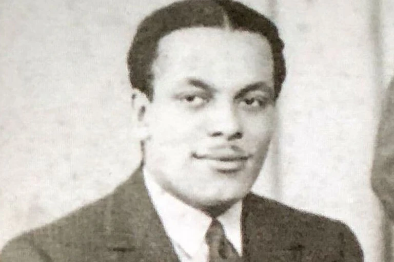 A portrait of Ivor Cummings wearing a suit.