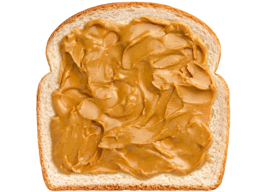 peanut butter spread on a piece of white sandwich bread