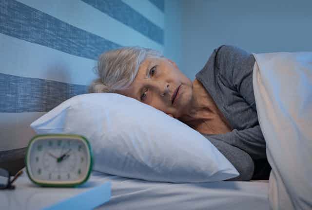elderly woman awake in her bed