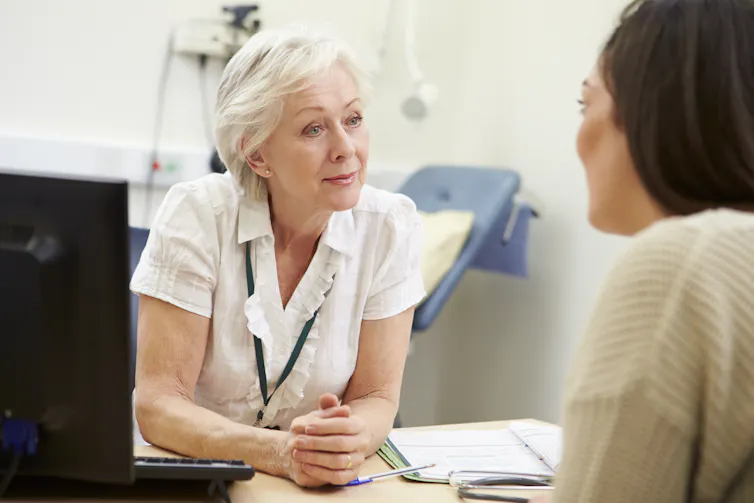 GP listens to patient