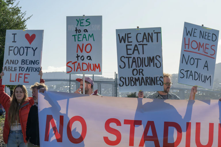 Protestors at press conference in Hobart on Saturday, April 29 2023, at which Prime Minister Anthony Albanese pledged $240 million to help the Tasmanian government build a new waterfront stadium in Hobart.
