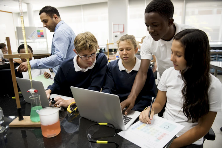 A science teacher does one experiment with students.