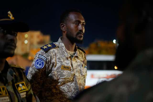 A Sudanese military officer watches evacuation operations in Port Sudan, May 2023