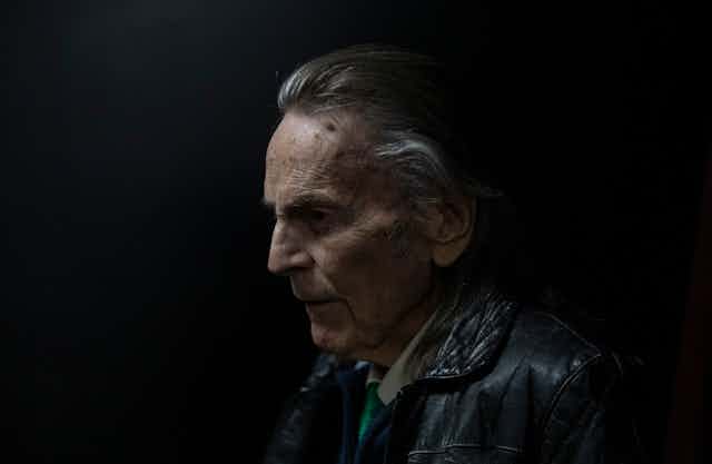 a profile photograph of an older gentleman against a dark background