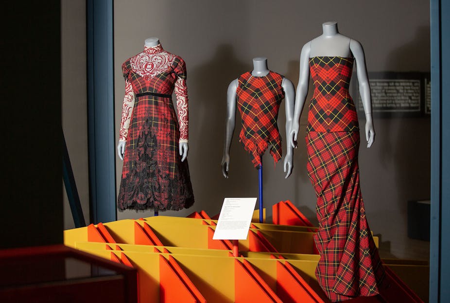 Two tartan dresses and a top on mannequins. 
