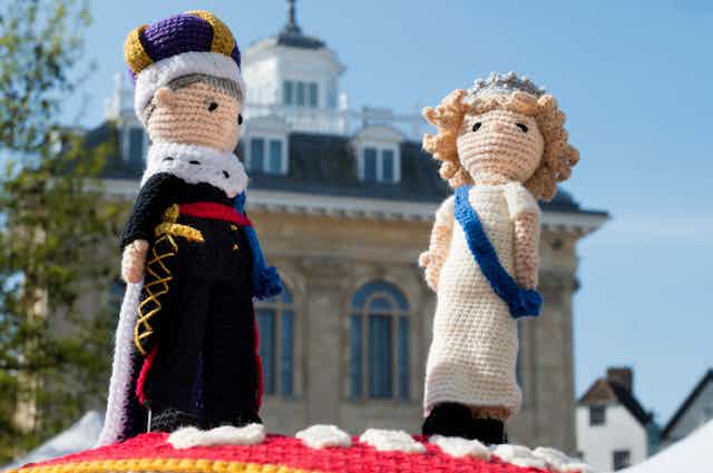 A knitted version of King Charles and Queen Camilla in regalia.
