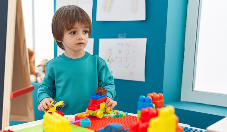 Toddler plays with blocks