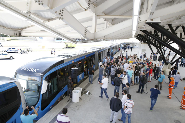 a bus rapid transit station with vehicles stopping for passengers