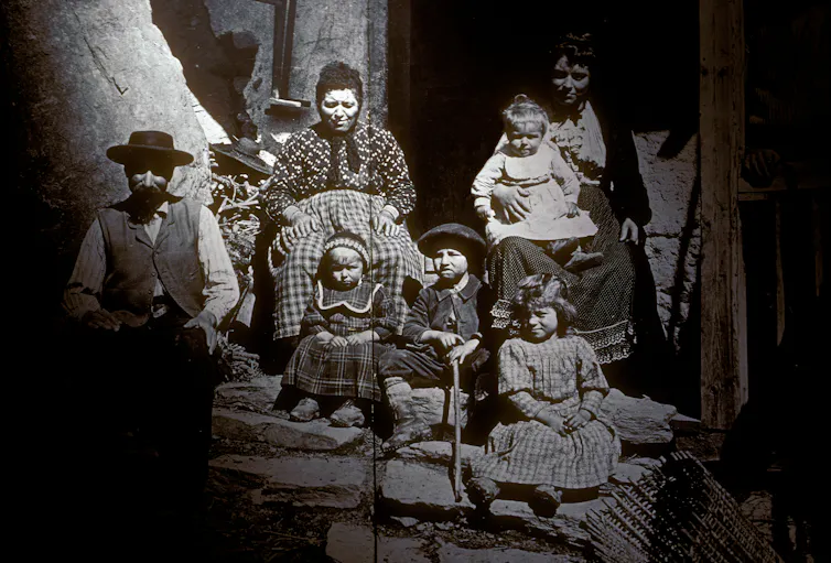 An archival photograph in black and white of people in historical clothing.
