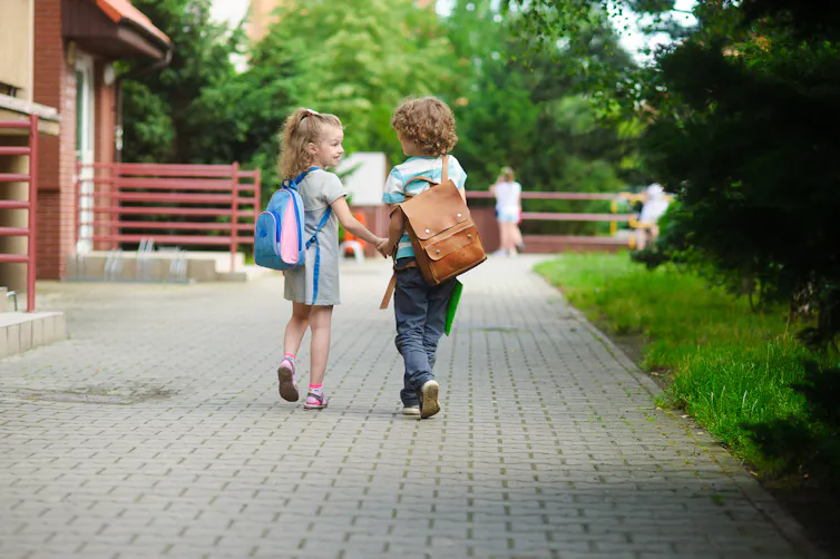 Two children holding hands