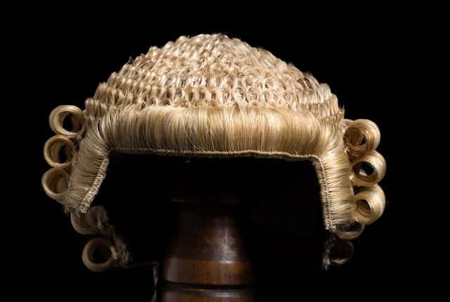 A judge's wig on a stand