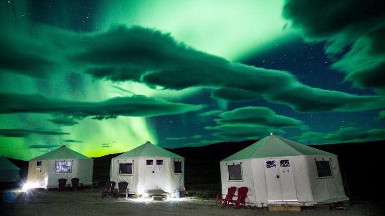 Tents below the northern lights.