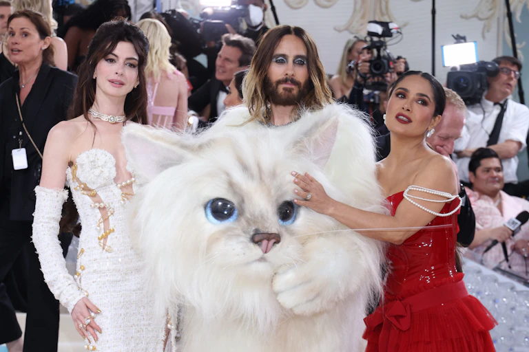 Anne Hathaway in a white dress, Jared Leto in his white cat costume and Salma Hayek in a red dress with pearl sleeves.