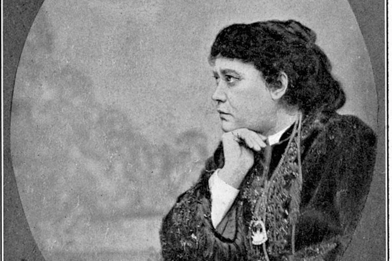 A black and white photo shows a pensive brunette woman, shown in profile.