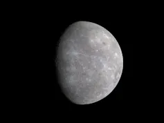 An image of Mercury - a partially obscured dark grey sphere with lots of texture created by many craters on its surface, on a black background