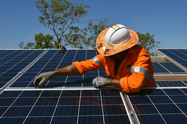 man installs solar panels