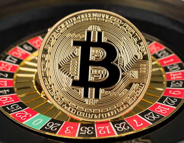 A bitcoin on top of a roulette wheel