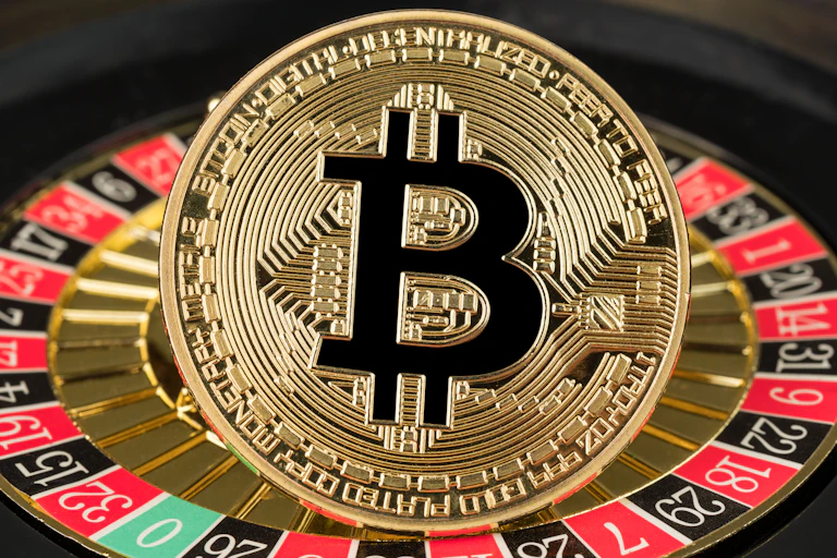A bitcoin on top of a roulette wheel