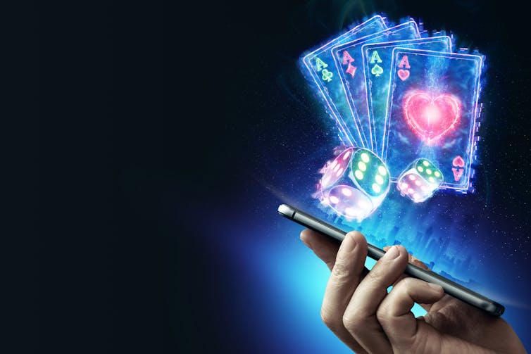 A smartphone with dice and cards coming out of it