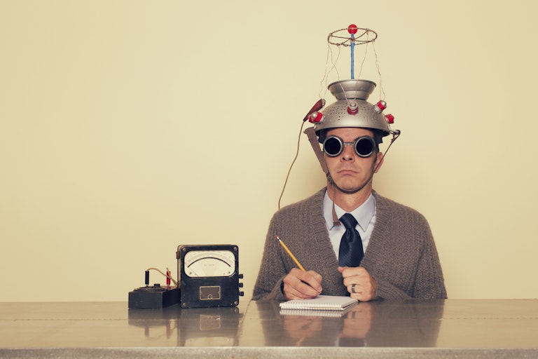 A man wearing a funny hat taking a test.