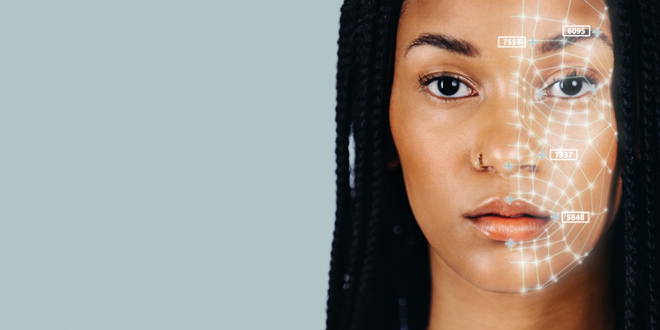 a young Black woman with long braided hair facing the camera with a web of white lines on the left side of her face