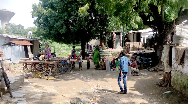 Neighbours interact in shared open space in Ramapir No Tekro.