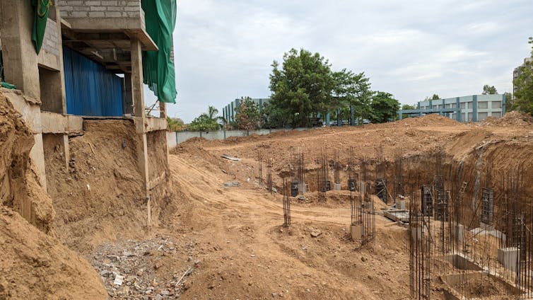 Foundations of apartment building located where houses and trees once were.