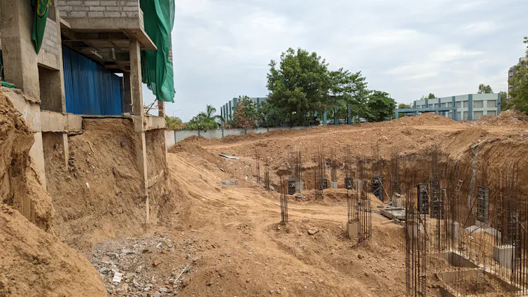 Foundations of apartment building located where houses and trees once were.