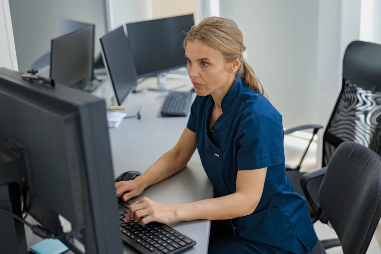 Nurse typing on computer