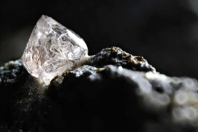 close-up of uncut diamond sitting on rock