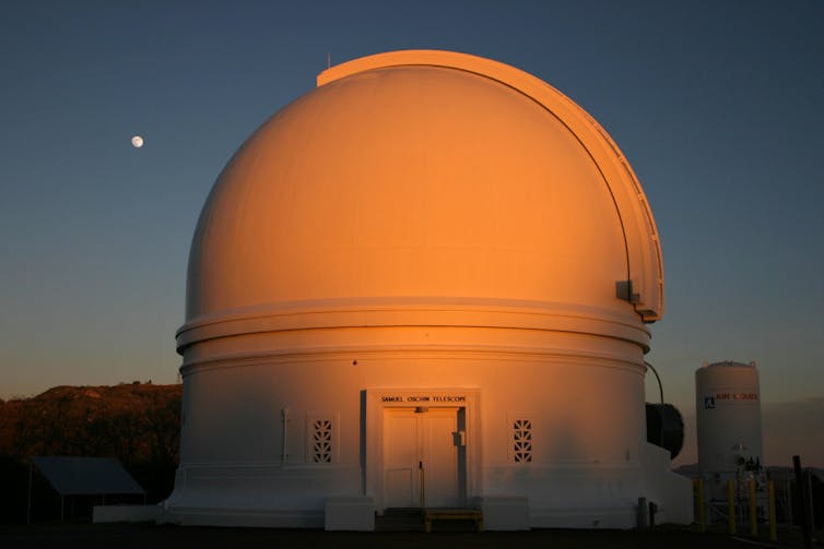 A white domed building at sunset.
