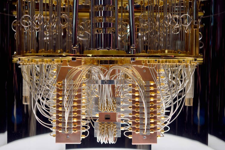 A photo of the brass coils and circuitry of a quantum computer.
