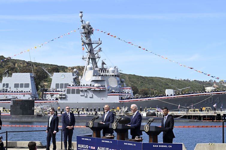 picture of Joe Biden and Anthony Albanese delivering speech in front of a navy vessel