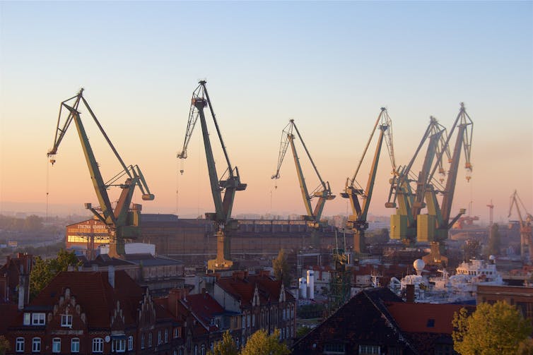 Giant shipyard cranes seen on the horizon at class=