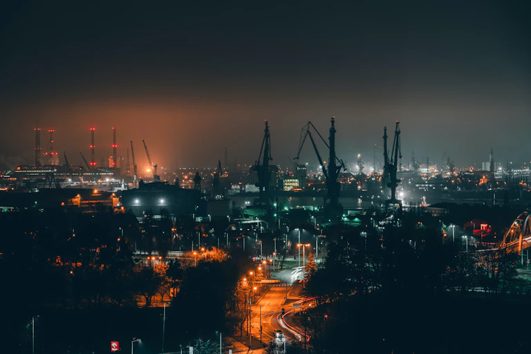 Shipyard cranes at night.