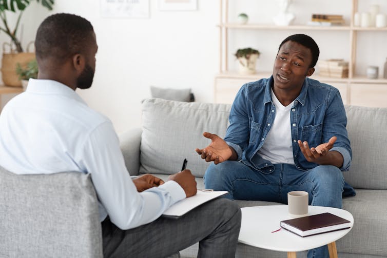 A young man speaks with his therapist.