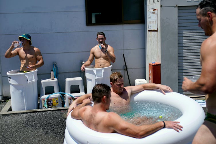 Men in ice baths outside.