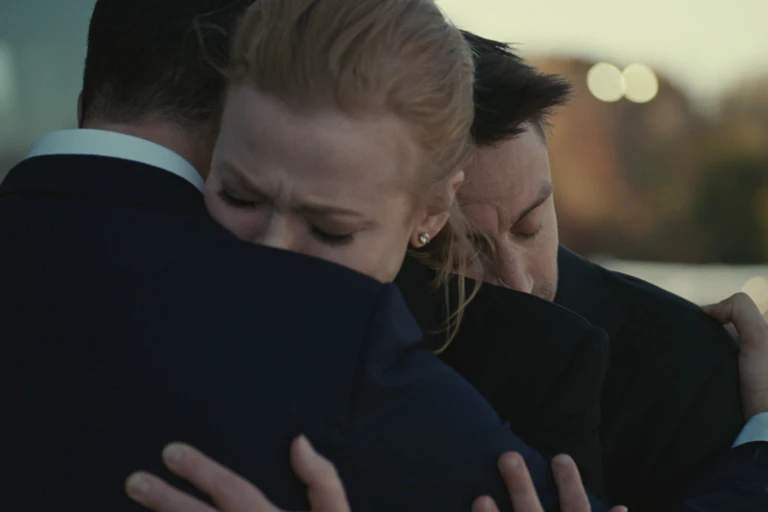 Three people hug