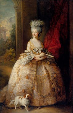 Painting of Queen Charlotte in large baby pink dress with a dog by her feet.