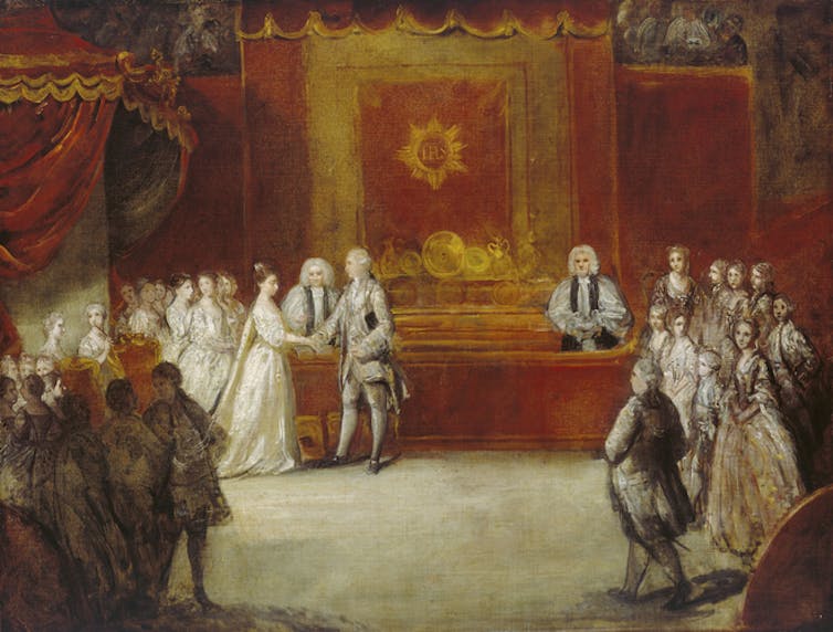 Charlotte and George holding hands surrounded by men of the court.