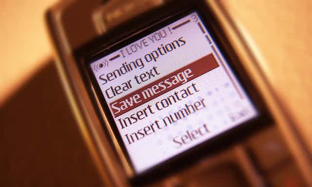 A 1990s-era smartphone displaying messaging options. 'Save message' is highlighted in the list of options.