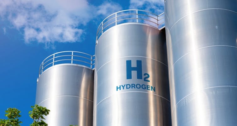 A photo of shining stainless steel tanks labelled with the word hydrogen