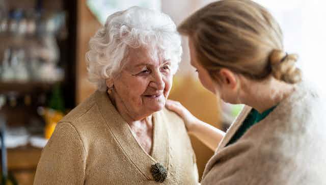 Older person interacts with a carer