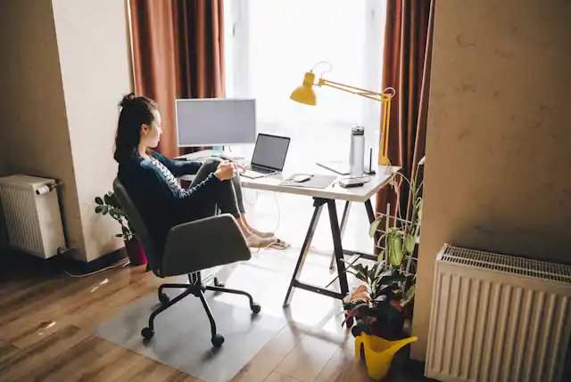 A woman working in a home office.