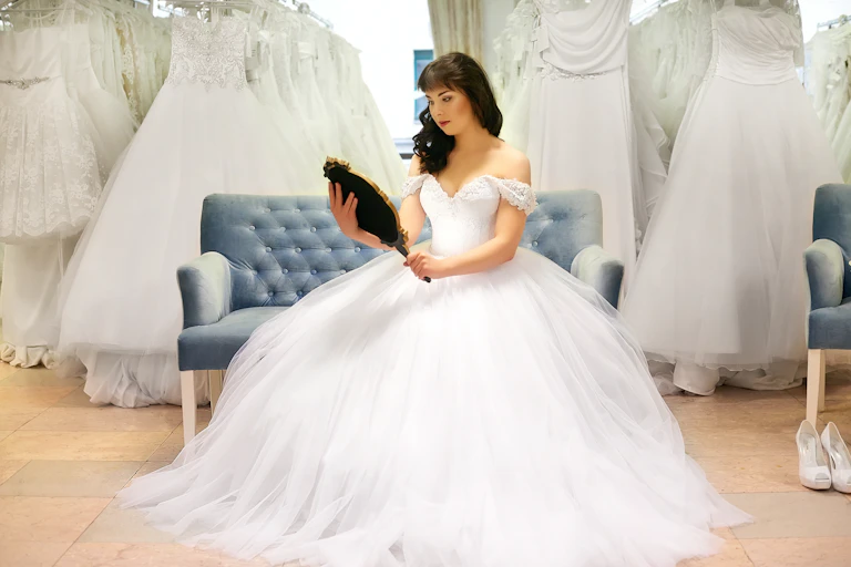 Bride in bridal shop looking in mirror