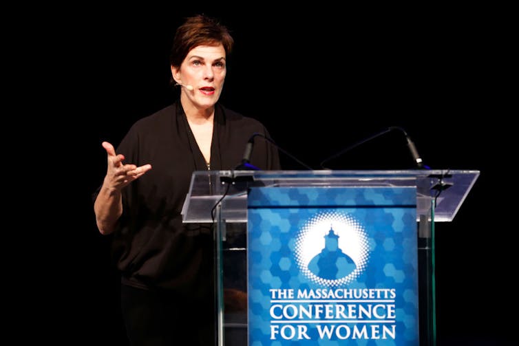 Woman speaking at a podium.