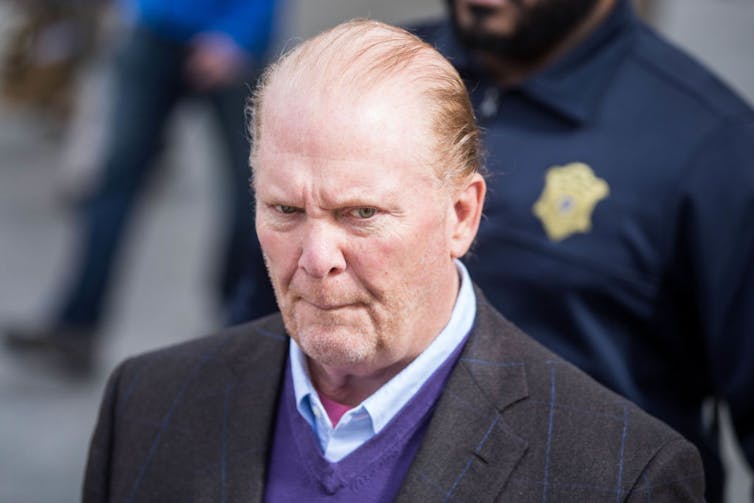 Portrait of balding man wearing suit.