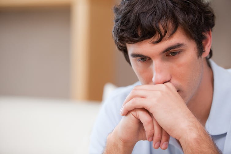 Young man, thinking, hand in hand, on chin