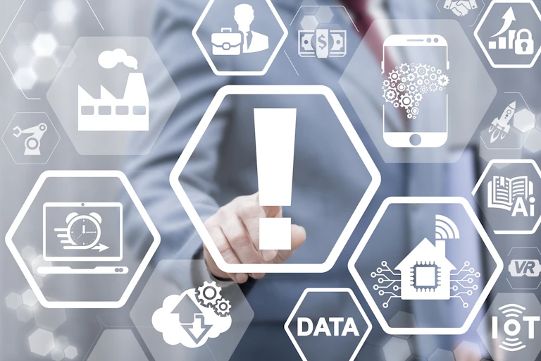 a man in a suit points at digitally transposed icons, including those representing wifi, data, a clock, a factory and a large central exclamation point