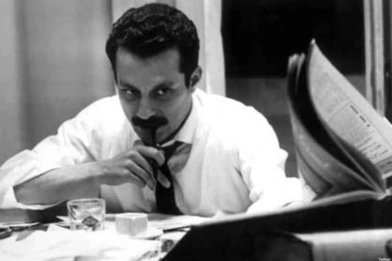 Palestinian novelist and intellectual Ghassan Kanafani working at a desk.